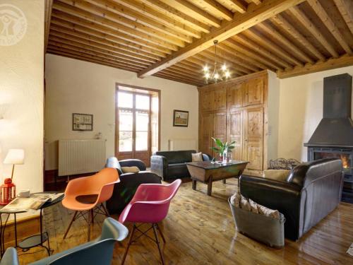 a living room with leather furniture and a fireplace at Gîte chaleureux avec cheminée, espace jeux et animaux, proche nature et activités familiales - FR-1-496-315 in Sauvain
