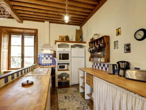 a kitchen with white appliances and a wooden counter top at Gîte chaleureux avec cheminée, espace jeux et animaux, proche nature et activités familiales - FR-1-496-315 in Sauvain