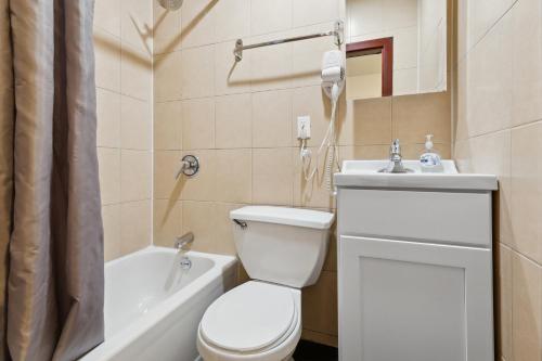 a bathroom with a toilet and a sink and a shower at Unique 2BD Apartment in Perfect Location next to Time Square in New York