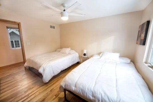 a bedroom with two beds and a ceiling fan at Tucked Away Off Brady - 4 Beds in Milwaukee
