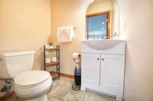 a bathroom with a white toilet and a sink at Tucked Away Off Brady - 4 Beds in Milwaukee