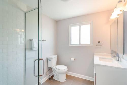 a bathroom with a toilet and a glass shower at Stunning 2 Floor Penthouse Downtown in Chicago