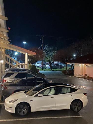 a white car parked in a parking lot at night at Slumber Lodge in Hope