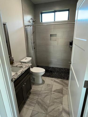 a bathroom with a toilet and a sink at Two bedroom with river access in Redding
