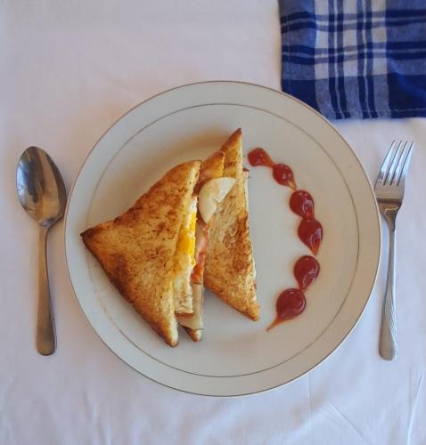 a white plate with two slices of food on it at FX72 Labuan Bajo Hotel in Labuan Bajo