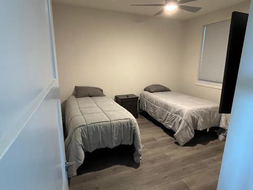 a bedroom with two beds and a window at Two bedroom with river access in Redding