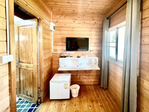 a bathroom with a white sink and a mirror at Tree Scape Mountain View Resort in Ban Pong