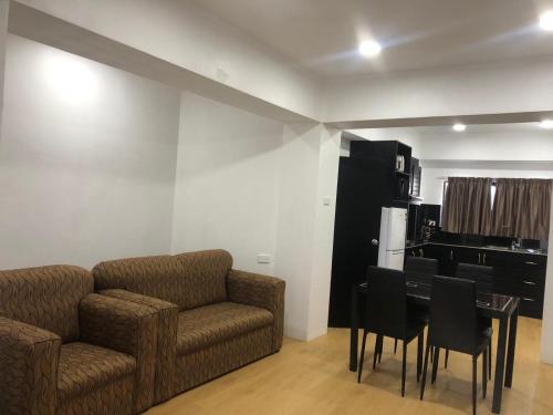 a living room with a couch and a table with chairs at Holiday Hire Fiji in Lautoka
