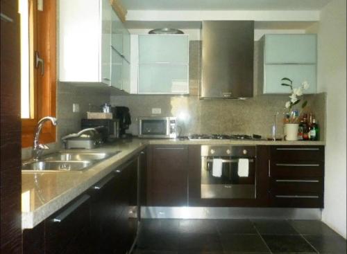 a kitchen with a sink and a stove top oven at VIP Terrenas Service in Santa Bárbara de Samaná