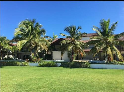 a house with palm trees in front of it at VIP Terrenas Service in Santa Bárbara de Samaná