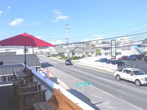 a view of a street with a red umbrella and a road at Beach Haven w/Spacious Balcony in Hampton