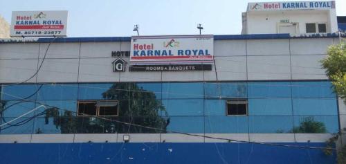 a building with a sign on the side of it at OYO Flagship Karnal Royal in Karnal