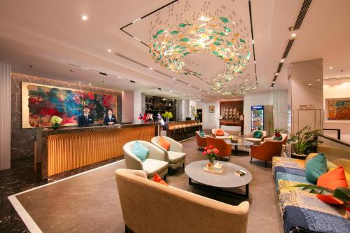 a lobby of a hotel with couches and a bar at Grand Cititel Hanoi Hotel & Spa in Hanoi