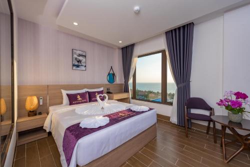 una camera d'albergo con un letto grande e una finestra di Maison Hotel PQ - by BAY LUXURY a Phu Quoc