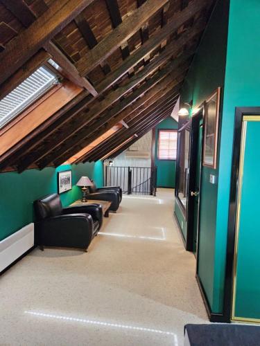 a living room with couches and a green wall at The Camperdown Mill in Camperdown