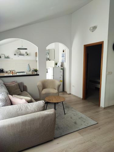 a living room with a couch and a table at Apartment Nika in Umag