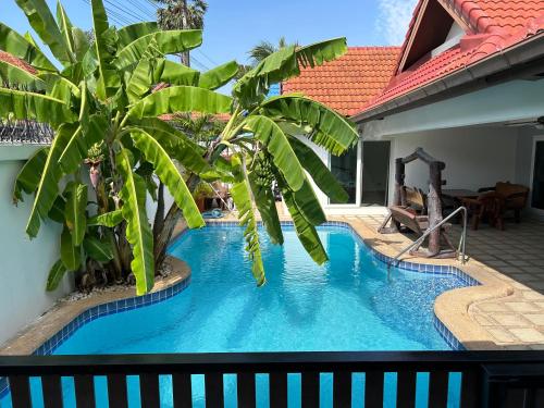 a swimming pool in the middle of a house at Nirvana pool villa 2 in Nong Prue