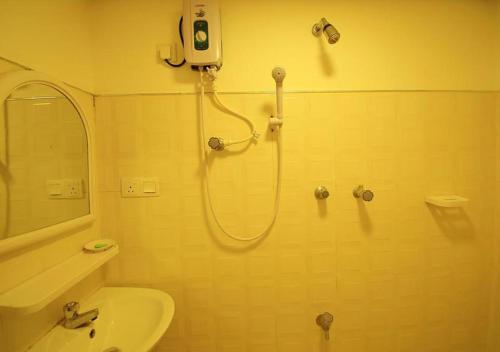 a bathroom with a shower and a sink at Yuthika Resort in Negombo