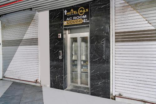 a building with a sign on the side of it at FabHotel Max in Vadodara