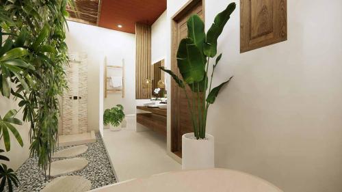łazienka z wazą z roślinami w obiekcie Villa Sebelah by Optimum Bali Villas w mieście Seminyak