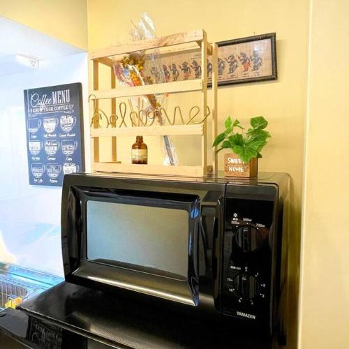 a microwave oven sitting on top of a table at InatoRelux in Inatori