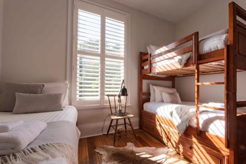 een slaapkamer met 2 stapelbedden en een raam bij Historic Beauty in the CBD with Parking & WiFi in Launceston