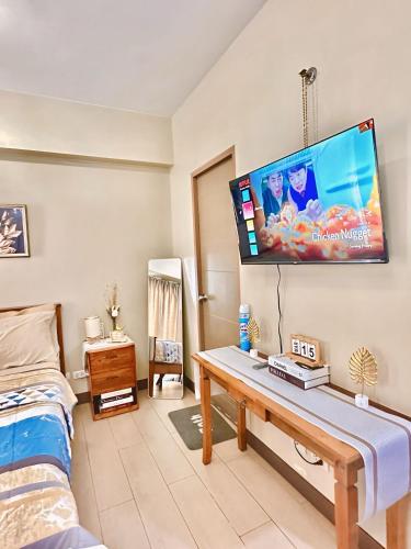 a room with a table and a tv on the wall at Condo in Newport City Pasay near NAIA T3 AIRPORT MANILA in Manila