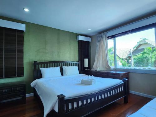 a bedroom with a large bed and a large window at Deluxe Pool Villa close to Beach and Walking Street! in Pattaya