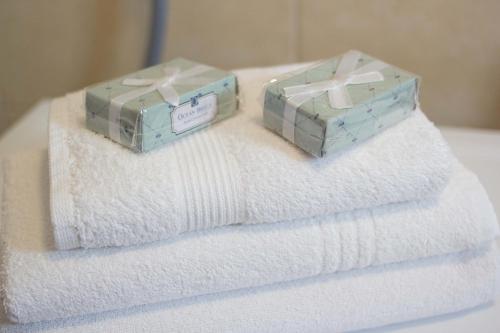 two boxes of towels sitting on a pile of towels at Adela Apartments - Beach Žnjan Split in Split