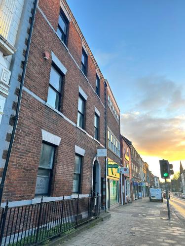 a brick building on a city street with a traffic light at Bridge Steet Apartments in Morpeth