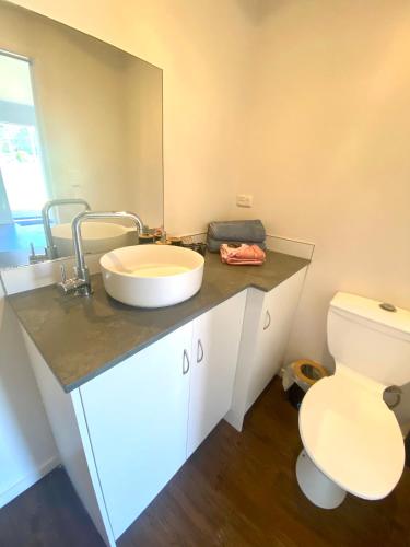 a bathroom with a sink and a toilet at Strahan Accomodation Units in Strahan