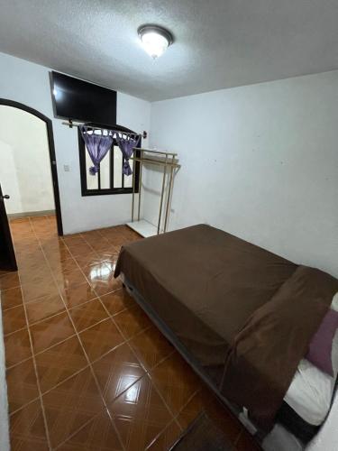 a room with a bed in the corner of a room at Casa genesis in Panajachel