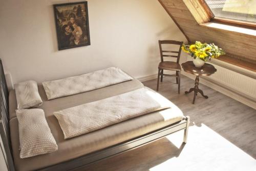 a bedroom with a bed and a table and a chair at Ferienwohnung Kaim in Prichsenstadt