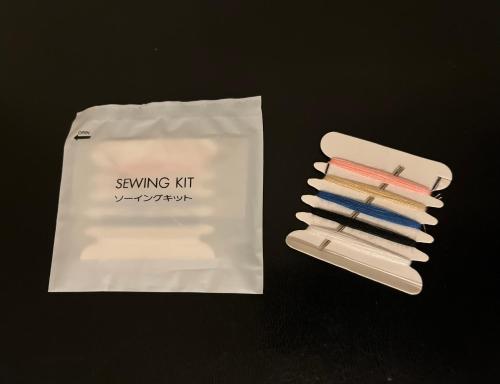 a group of four toothbrushes sitting next to a bag at Dormy Inn Tomakomai in Tomakomai