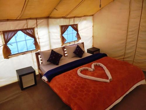 a bedroom with a heart shaped bed in a tent at Northern Valley Camp - Nubra in Hundar