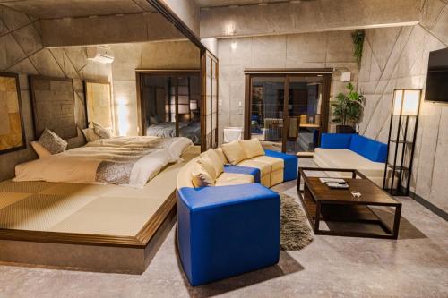 a bedroom with a large bed and a couch at XYZ speciale in Shirahama