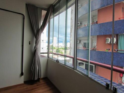 a room with a large window with a view at Studio La Amazon in Belém