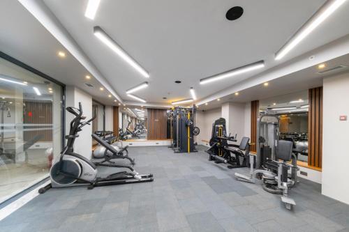 a gym with treadmills and cardio equipment in a room at Riviera Zen Hotel Adult Only in Alanya