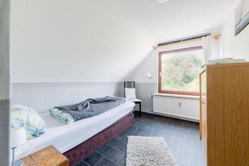 a small bedroom with a bed and a window at Private House in Hannover