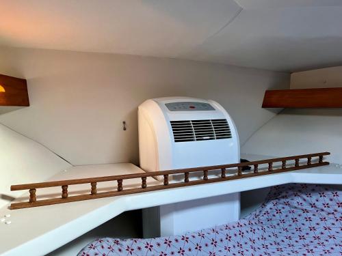 a room with a air conditioner on a shelf at Cozy private two rooms yacht in Barcelona - boat in Port Forum in Barcelona