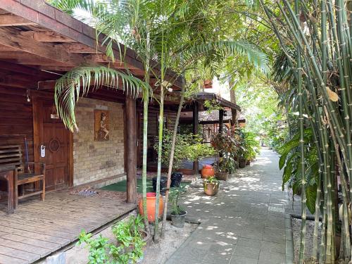 a porch of a house with trees and plants at Samed sand sea resort in Ko Samed