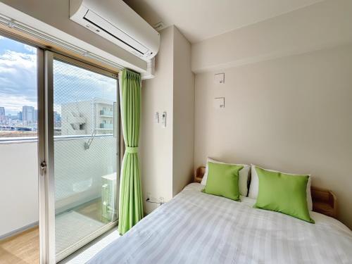 Ένα ή περισσότερα κρεβάτια σε δωμάτιο στο Nishinakajima Apartment