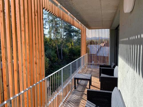 a balcony with two chairs and a wooden railing at Lakepark Residence in Staré Splavy