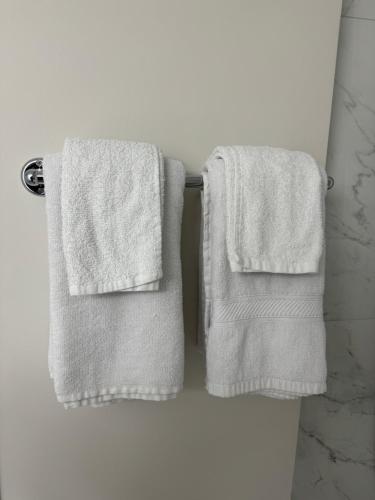 two towels hanging on a towel rack in a bathroom at Brand new 2 Bedrooms modern guest suite with separate entrance in Calgary