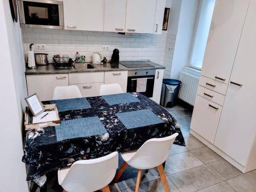 a kitchen with a table with chairs and a counter top at Christoph's Central Apartment in Budapest