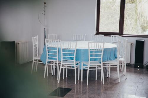 mesa de comedor con sillas y mantel azul en Theia's Garden, 