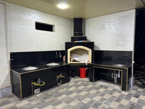a bathroom with two sinks and a fireplace at “DACHA” Hi-Tech by Dubai in Aranchi