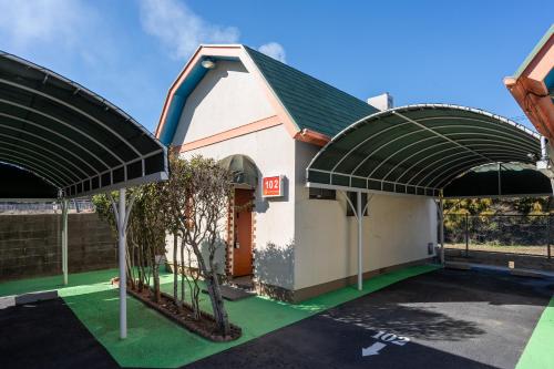 a building with awnings in a parking lot at Grand Hotel Narita Airport in Akaike