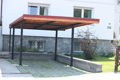 a wooden pavilion in front of a building at Apartment Gondola in Maribor