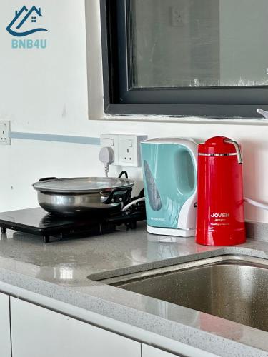 a kitchen sink with a toaster and a pan at Urban Suites Georgetown by BNB4U in Jelutong